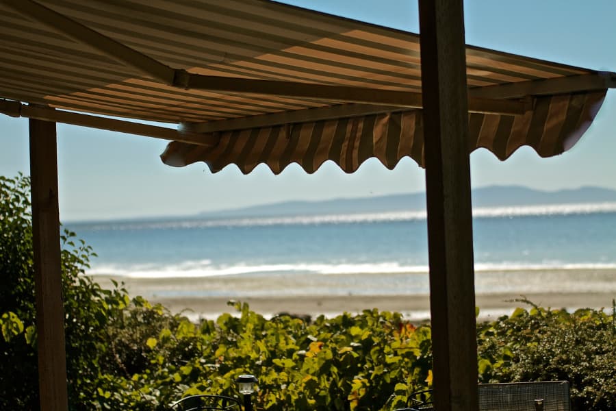 Retractable-Awning-Overlooking-the-Beach-with-Ocean-Waves Retractable Awning Overlooking the Beach with Ocean Waves