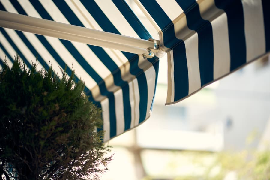 Low Angle Of A Blue And White Stripped Retractable Awning